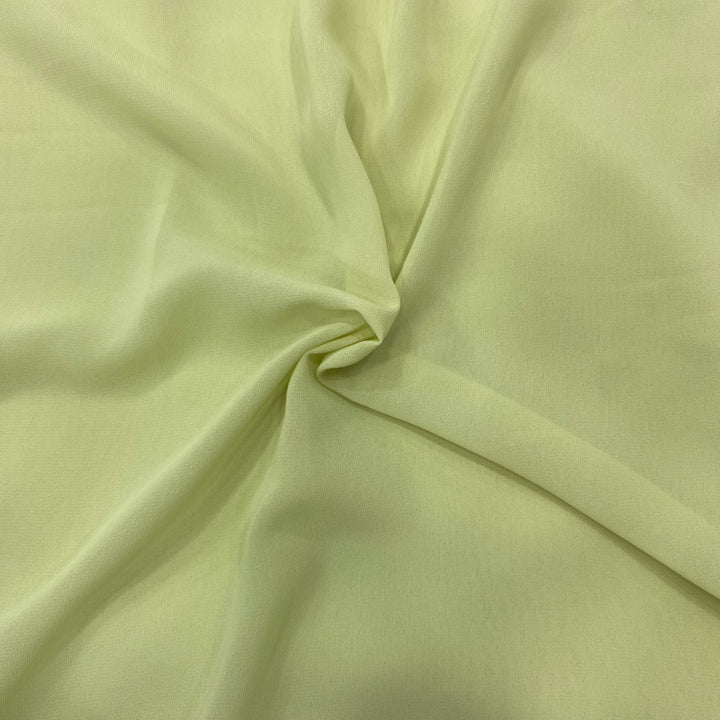 Pastel green georgette fabric swatch, soft and luxurious, perfect for flowly ensembles