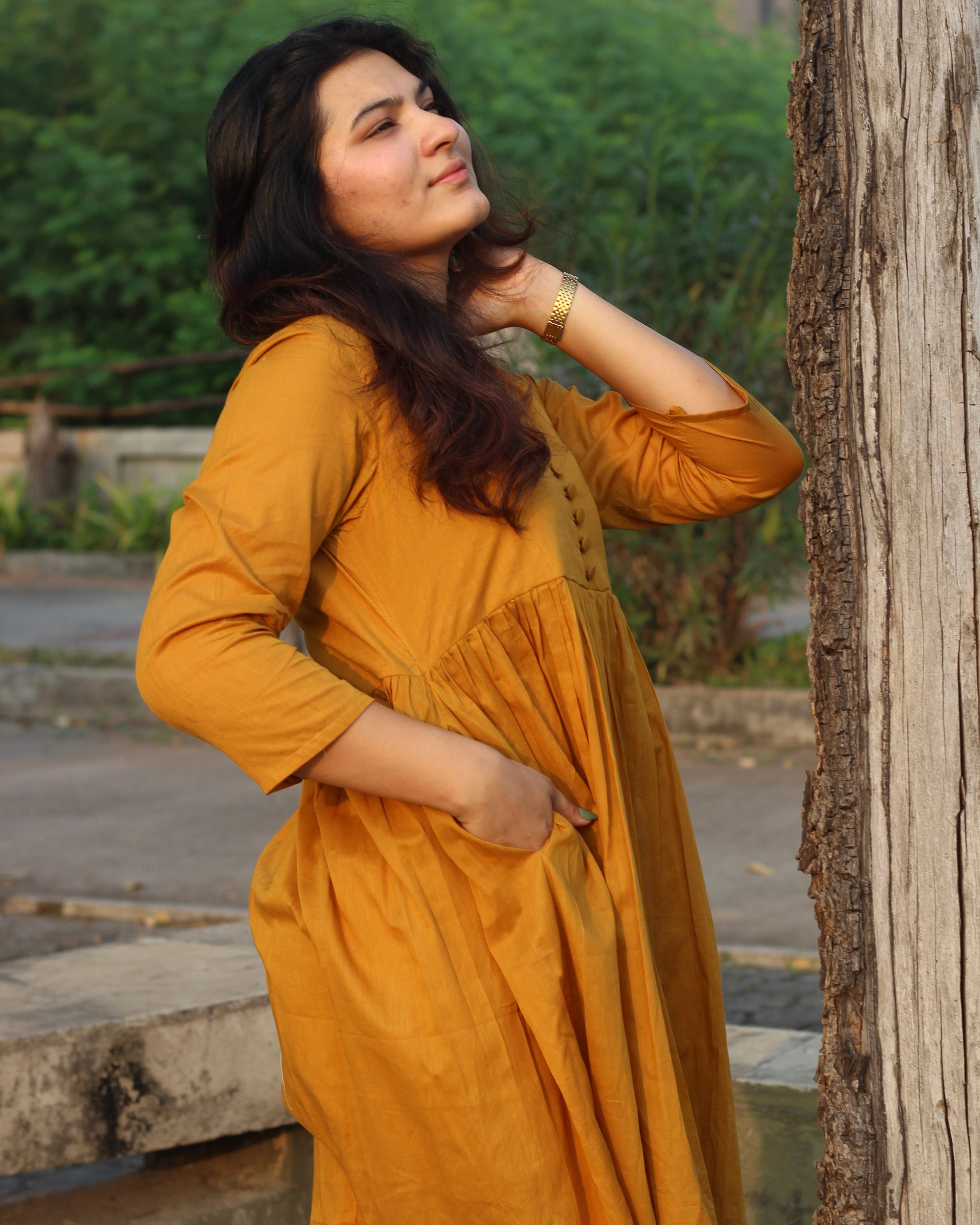 Mustard mul cotton kurta pant set with V-neck, cloth-covered buttons, pleated pattern from yoke, 3/4 sleeves, and pockets, in our best-selling design