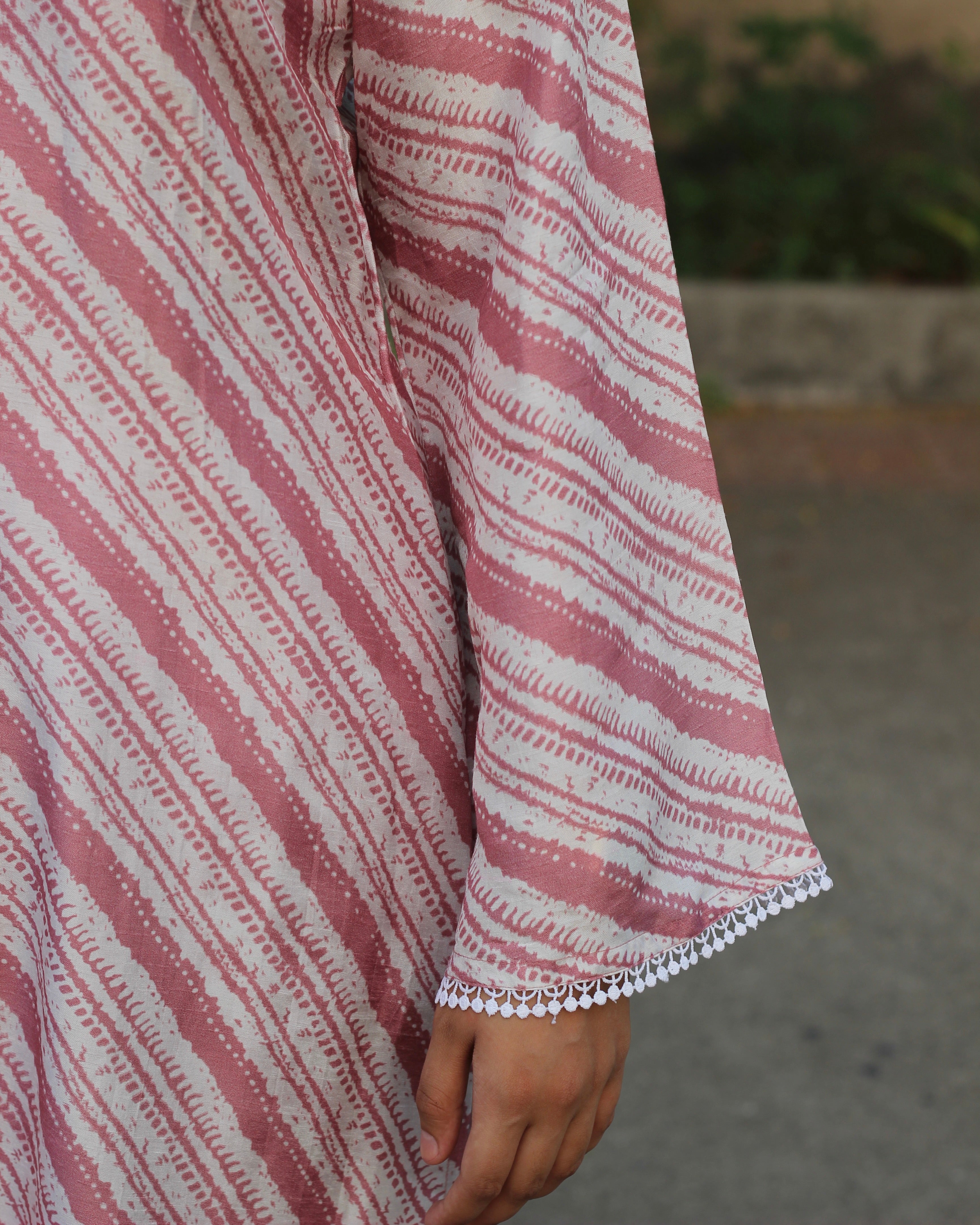 Leheriya print silk kurta set with pink on dull white, featuring V-neck with white lace details, long bell sleeves, and matching pants