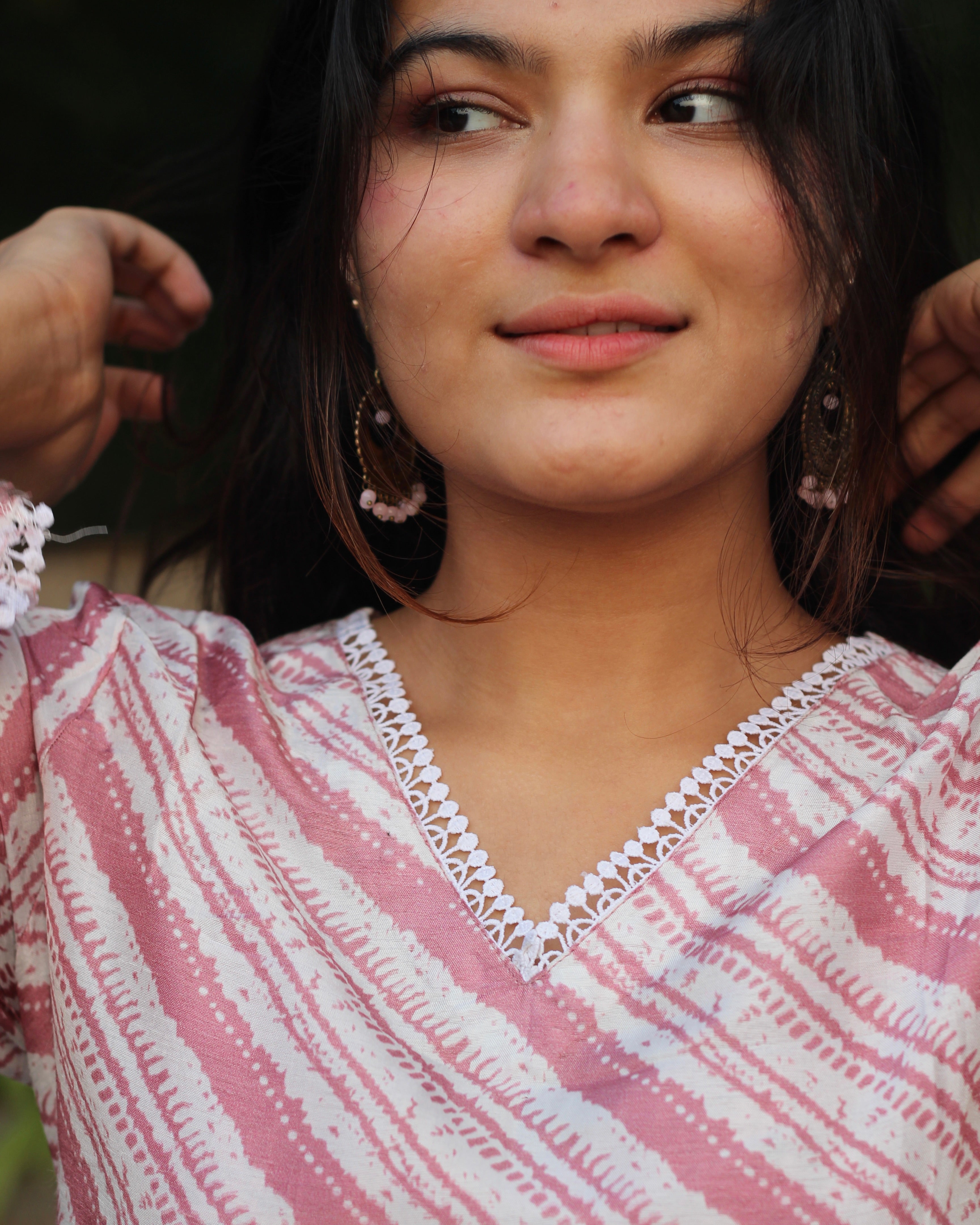 Leheriya print silk kurta set with pink on dull white, featuring V-neck with white lace details, long bell sleeves, and matching pants