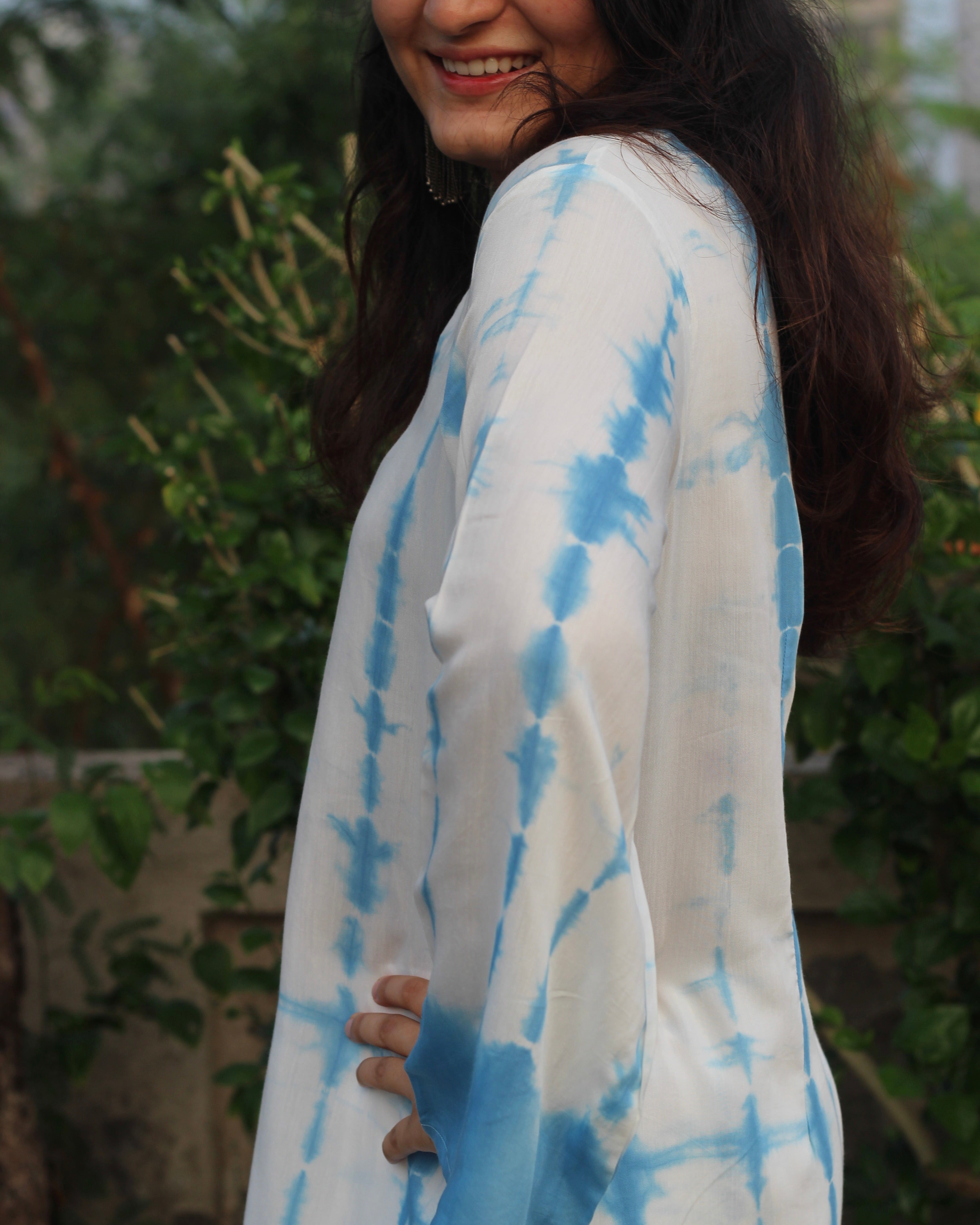 Shibori print muslin co-ord set featuring a knee-length straight kurta with V-neck and bell sleeves, paired with lined pants, in a white and blue palette