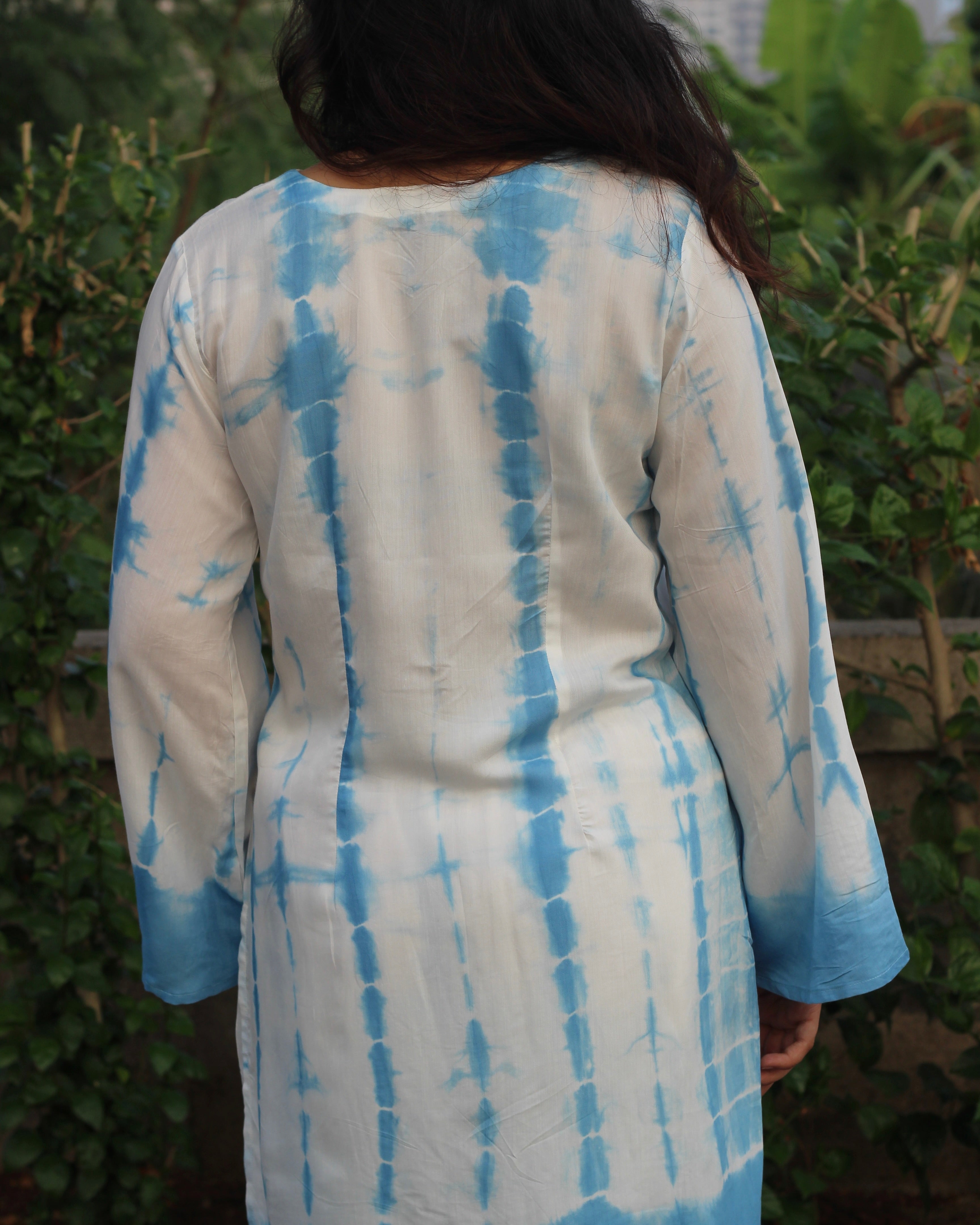 Shibori print muslin co-ord set featuring a knee-length straight kurta with V-neck and bell sleeves, paired with lined pants, in a white and blue palette