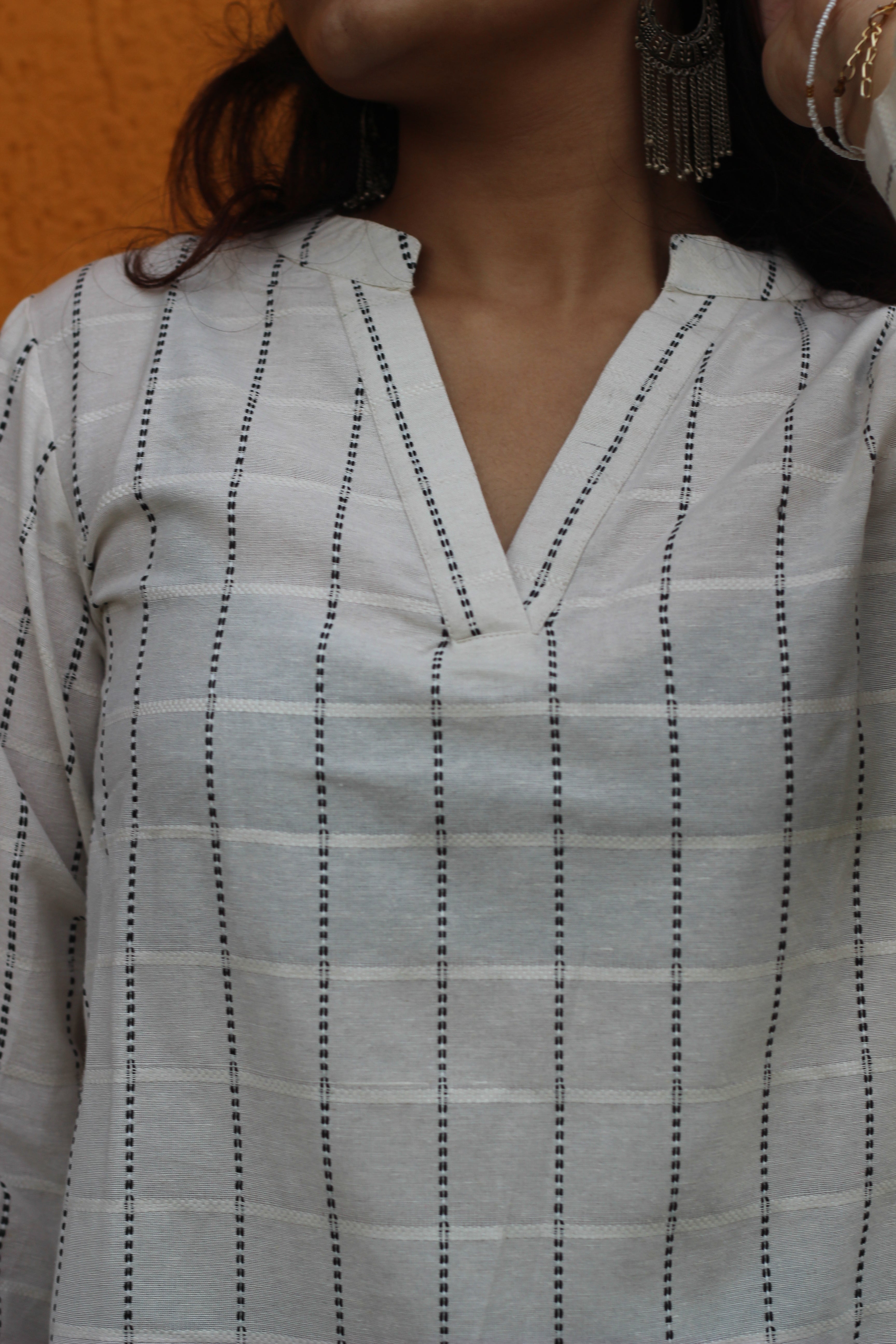 White handloom cotton short Kurta with V-neck and long sleeves, featuring elegant stripes, perfect for pairing with jeans