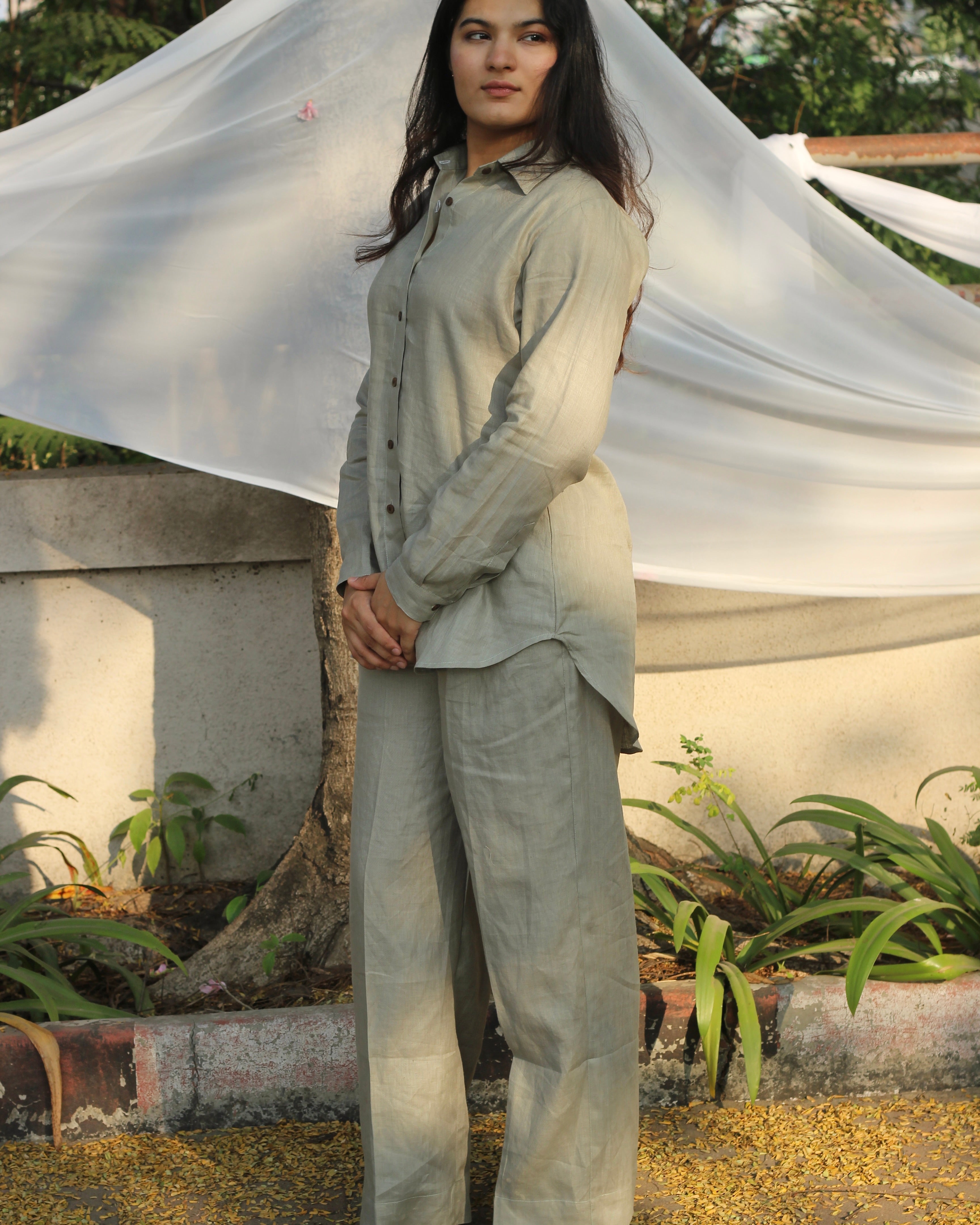 Sustainable fashion in action with a model showcasing a linen attire in a natural, sage green hue, ideal for eco-conscious individuals