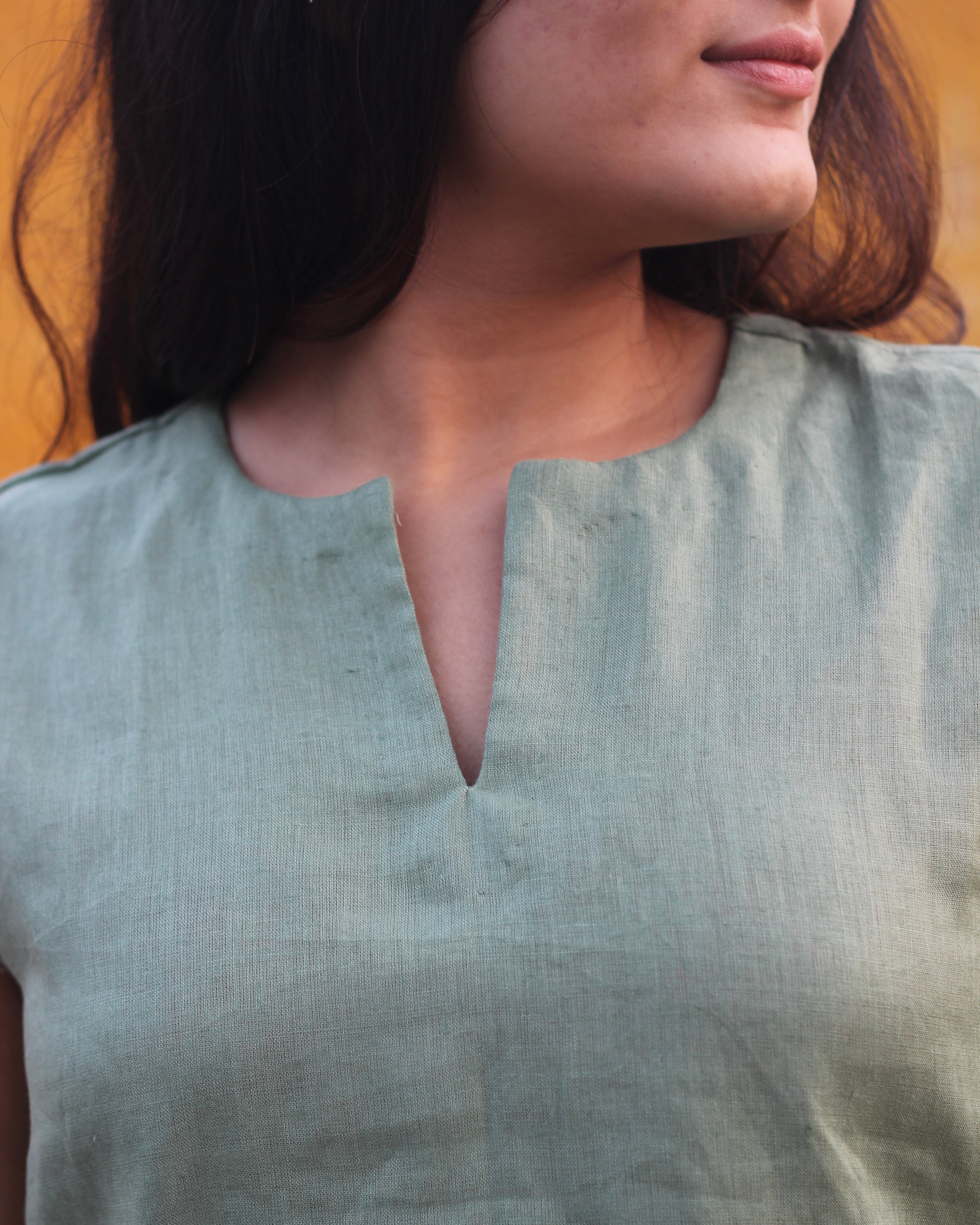 Premium linen sleeveless short kurta in Sage green, perfect for pairing with wide leg jeans for a brunch or casual workwear