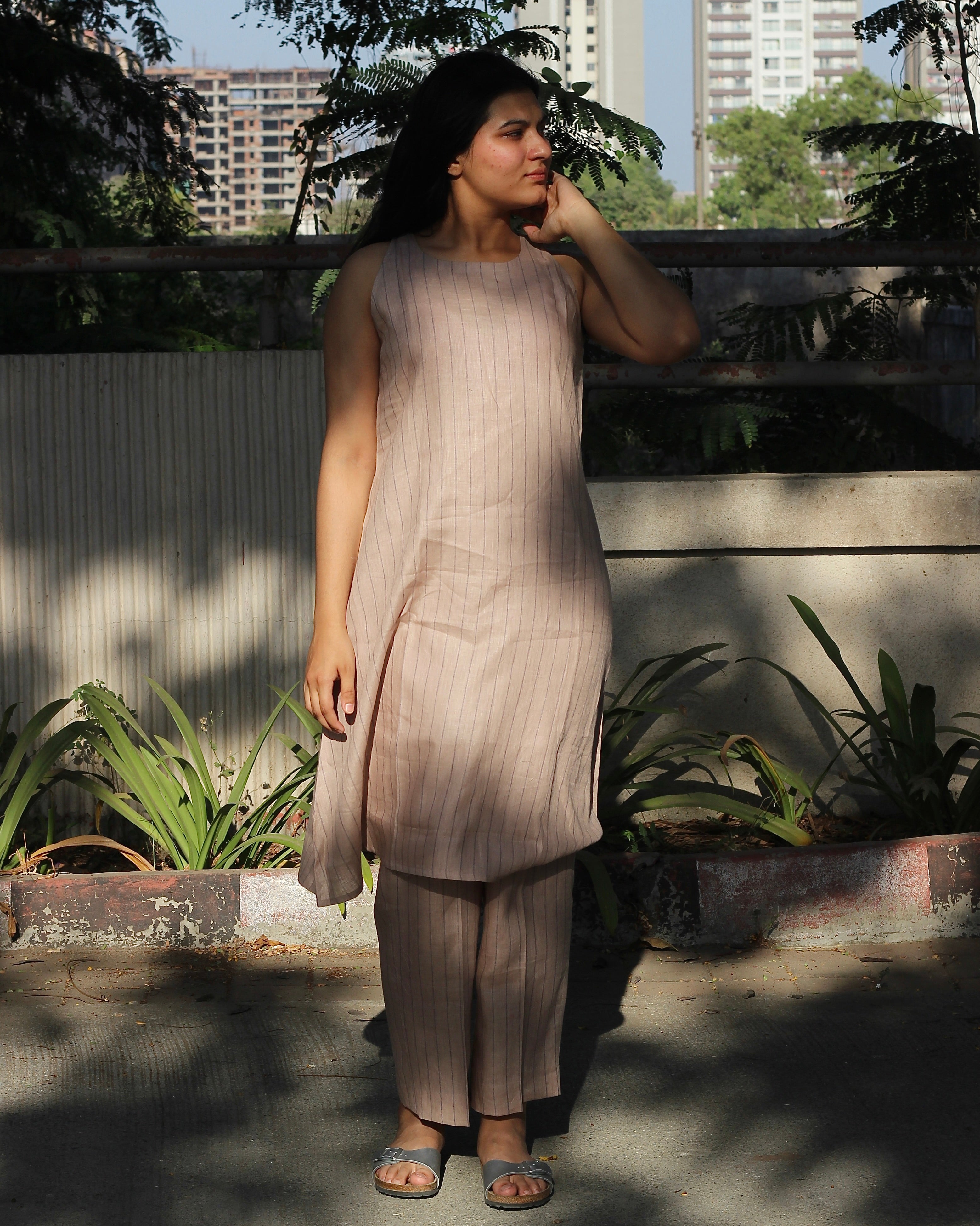 Sleeveless top and ankle-length pants in premium dusty pink linen with delicate light black stripes, featuring a unique long back loop detail