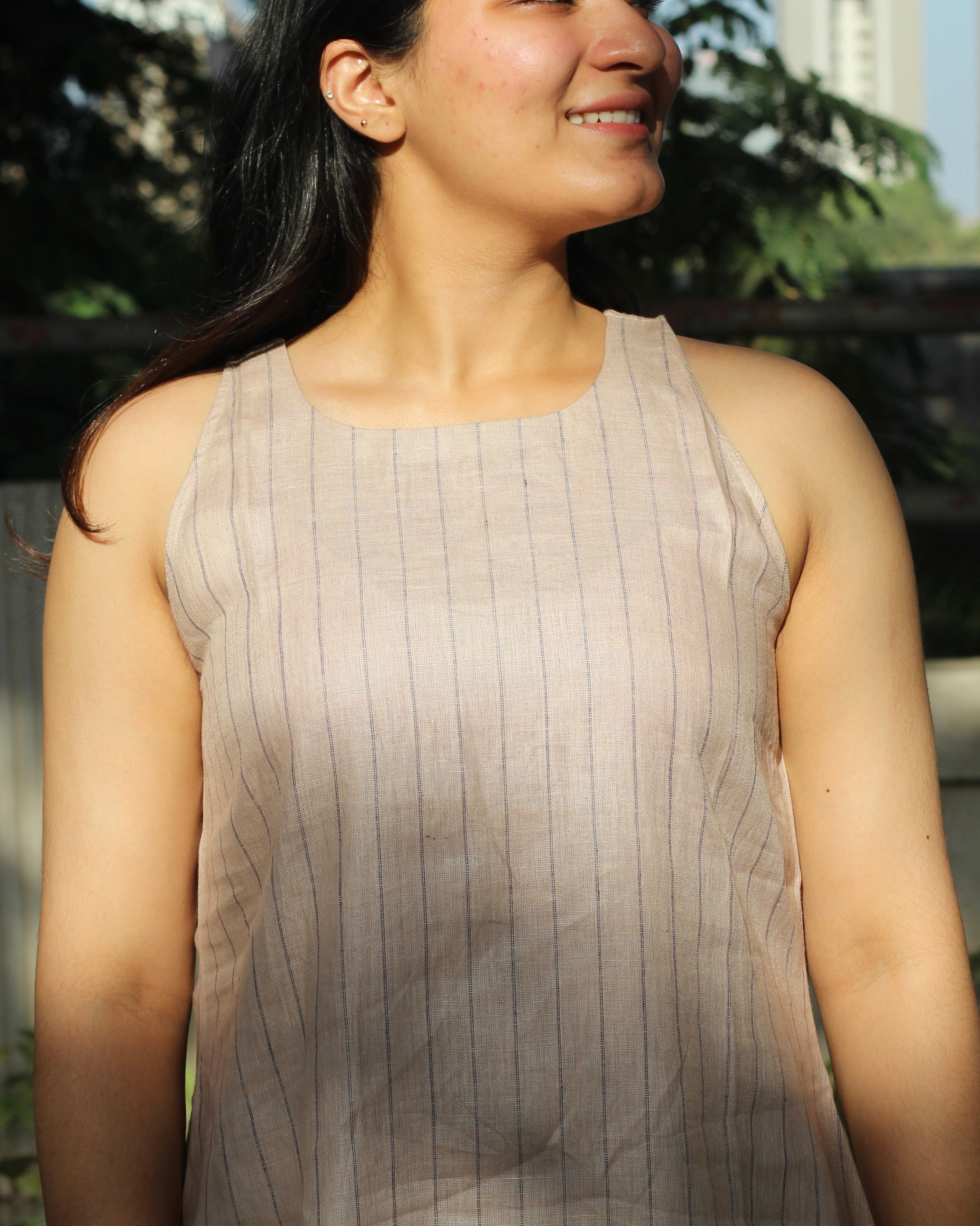 Sleeveless top and ankle-length pants in premium dusty pink linen with delicate light black stripes, featuring a unique long back loop detail