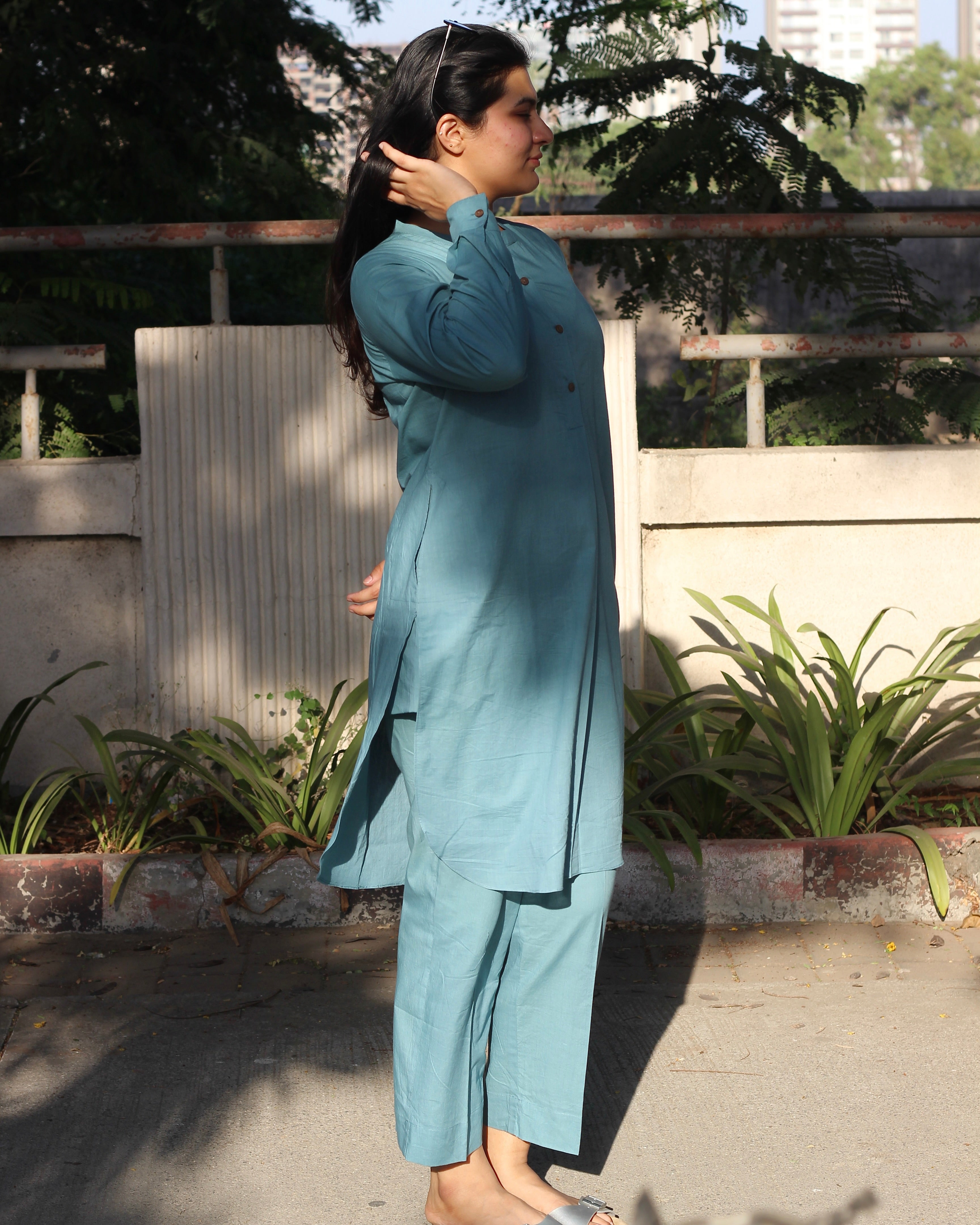 Pure Cambric Cotton Powder Blue Co-ord set featuring a long kurta with round side cuts and brown neck buttons, paired with soft and comfortable pants, ideal for versatile summer wear