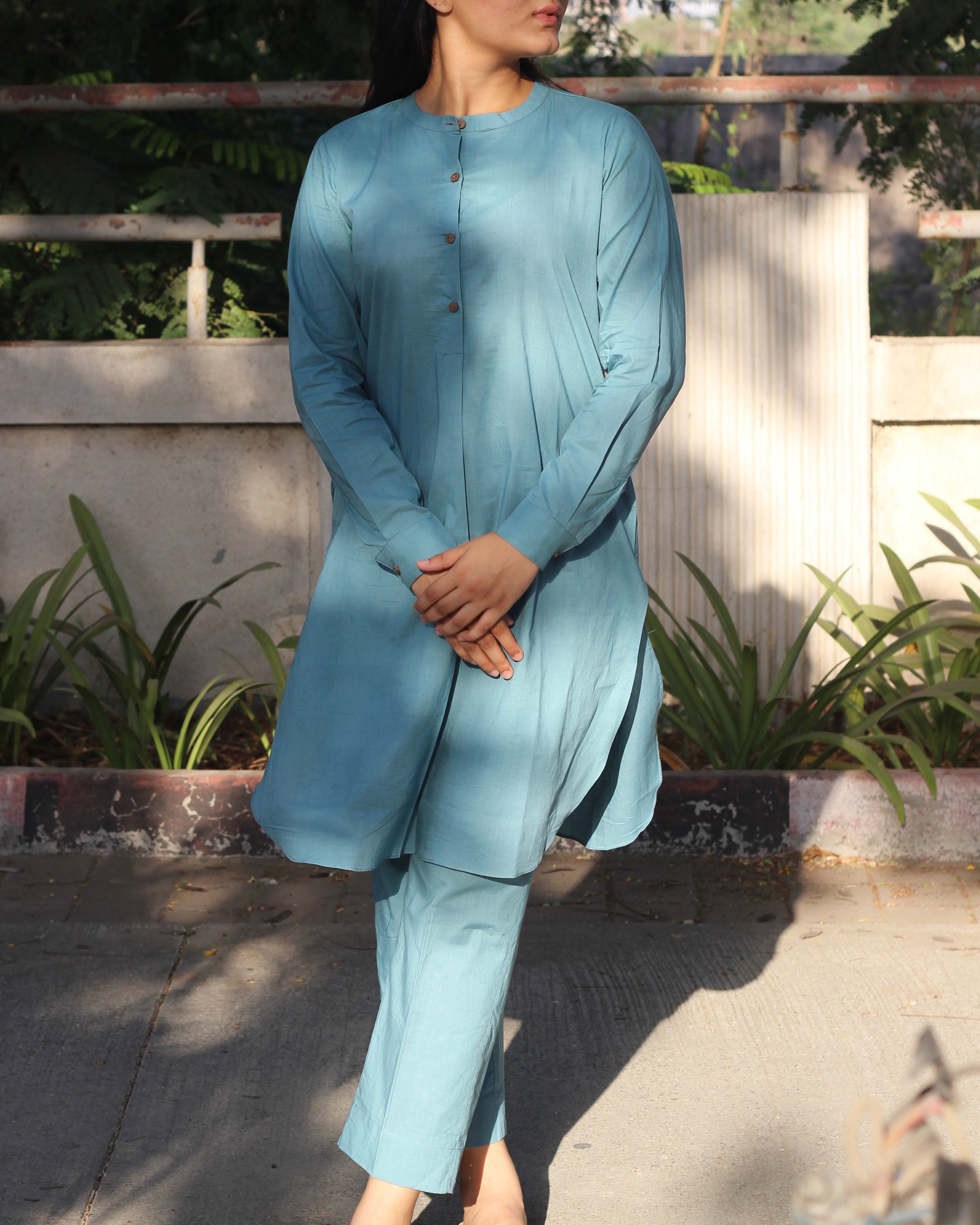 Pure Cambric Cotton Powder Blue Co-ord set featuring a long kurta with round side cuts and brown neck buttons, paired with soft and comfortable pants, ideal for versatile summer wear