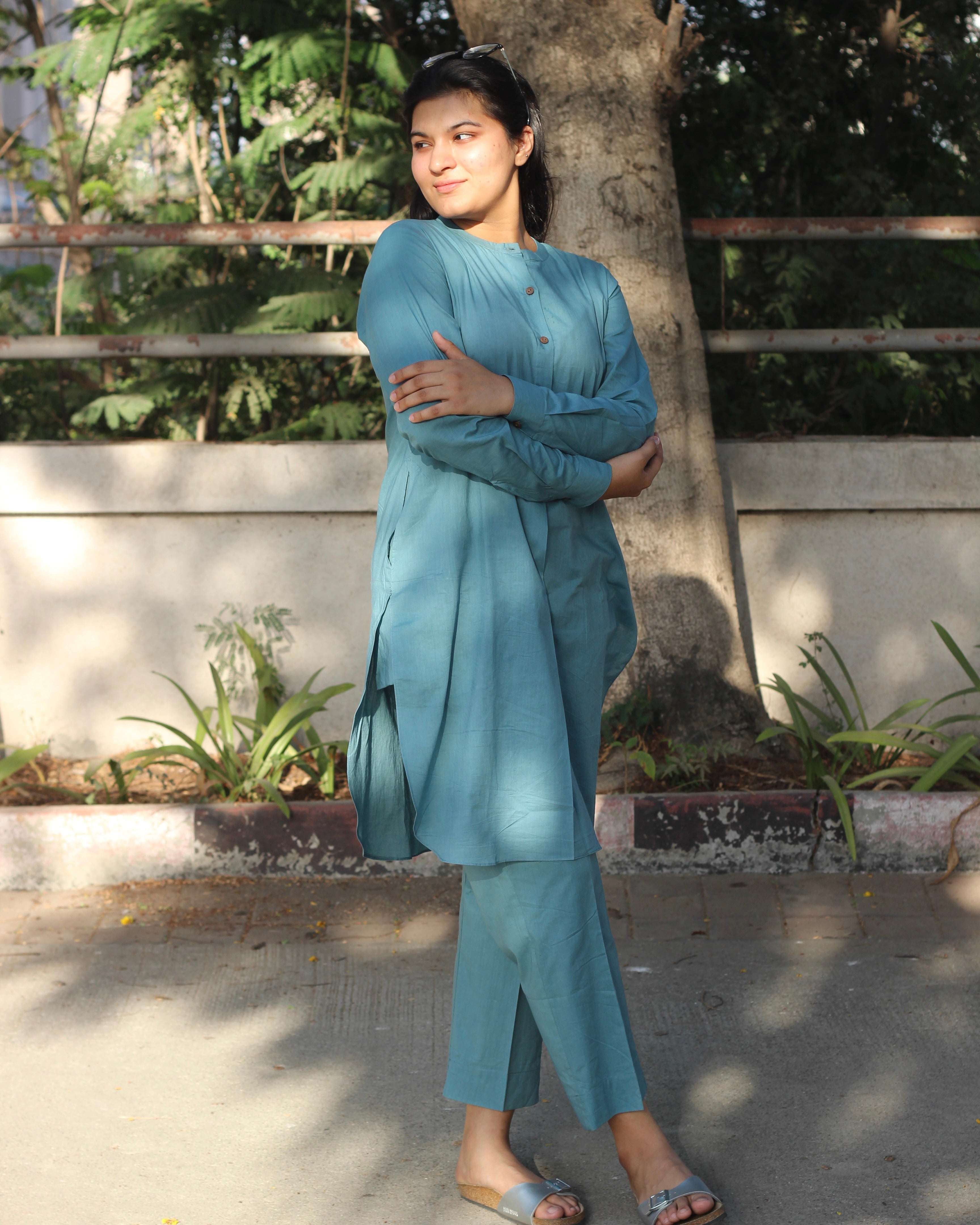 Pure Cambric Cotton Powder Blue Co-ord set featuring a long kurta with round side cuts and brown neck buttons, paired with soft and comfortable pants, ideal for versatile summer wear