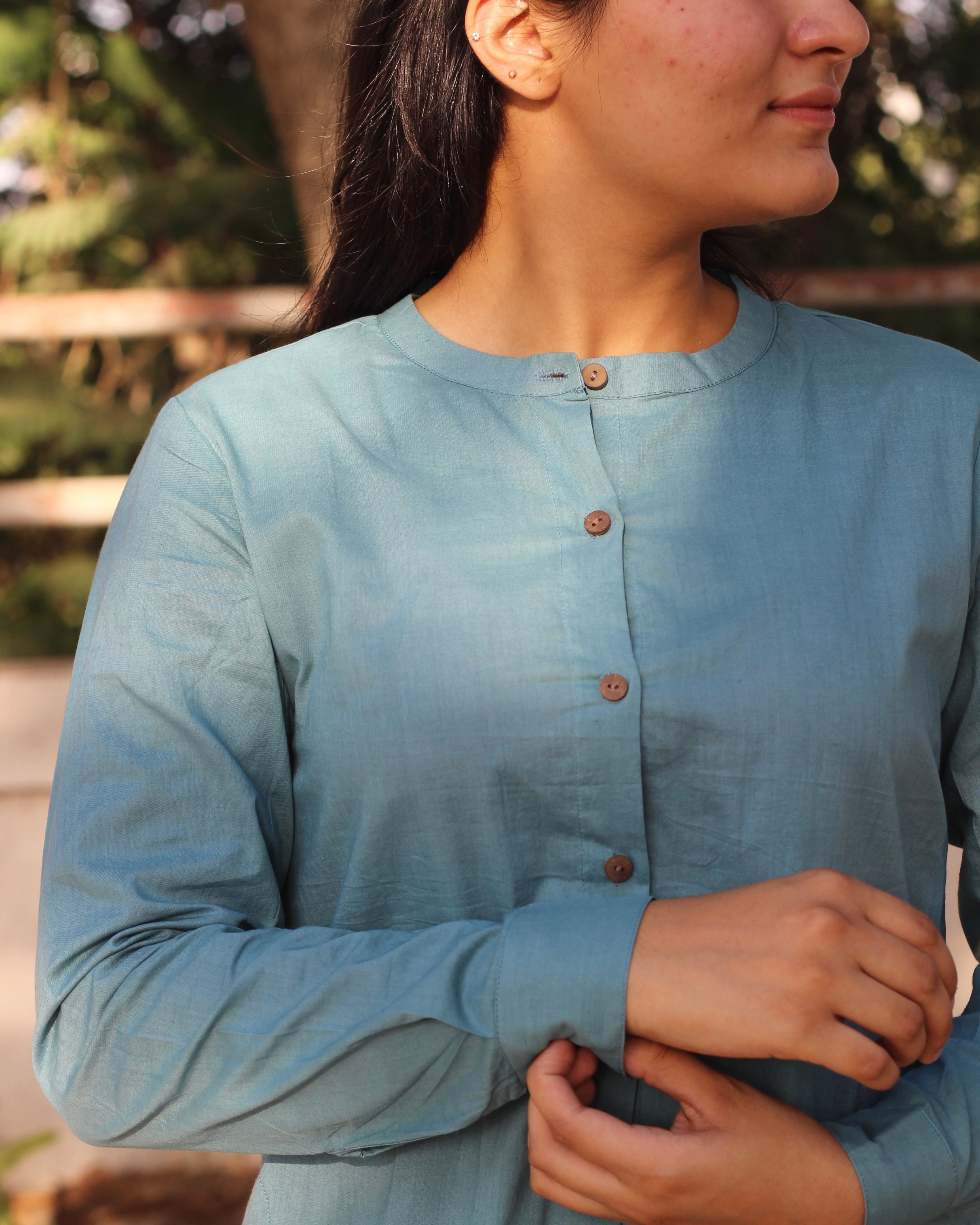 Pure Cambric Cotton Powder Blue Co-ord set featuring a long kurta with round side cuts and brown neck buttons, paired with soft and comfortable pants, ideal for versatile summer wear