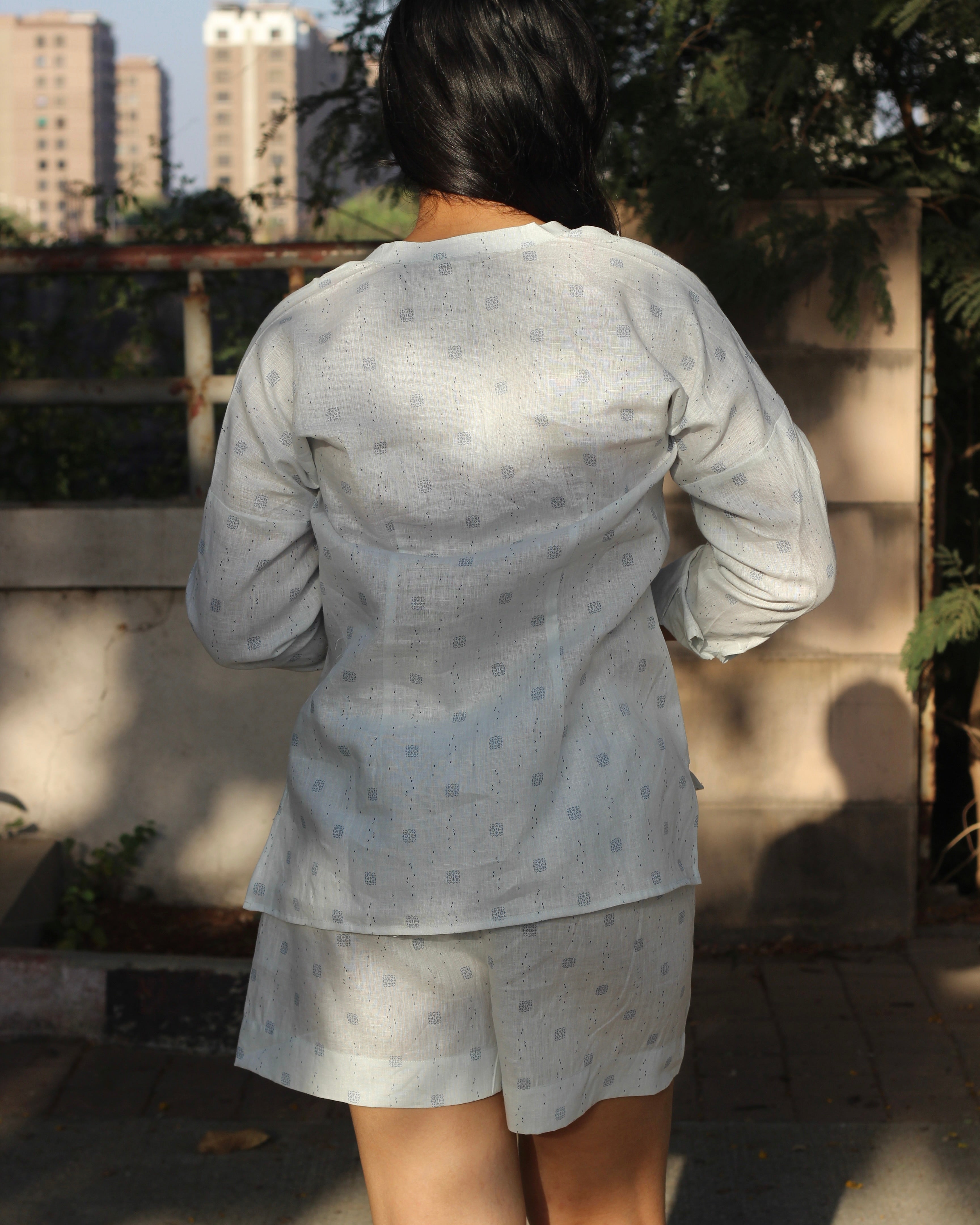 Premium Linen Abstract Printed Co-ord featuring a white V-neck shirt with stylish side cuts and matching shorts, ideal for a light and breezy summer day