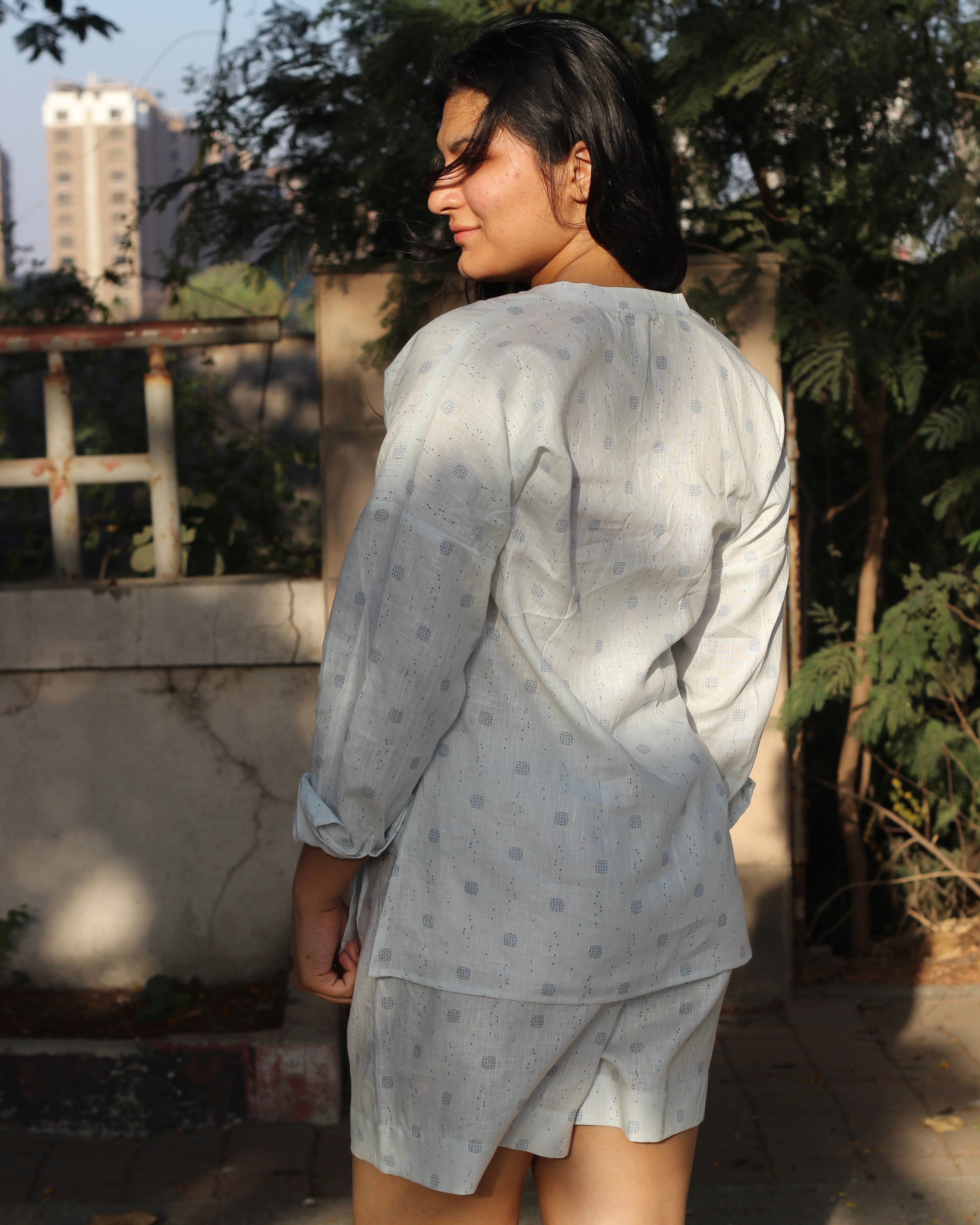 Premium Linen Abstract Printed Co-ord featuring a white V-neck shirt with stylish side cuts and matching shorts, ideal for a light and breezy summer day