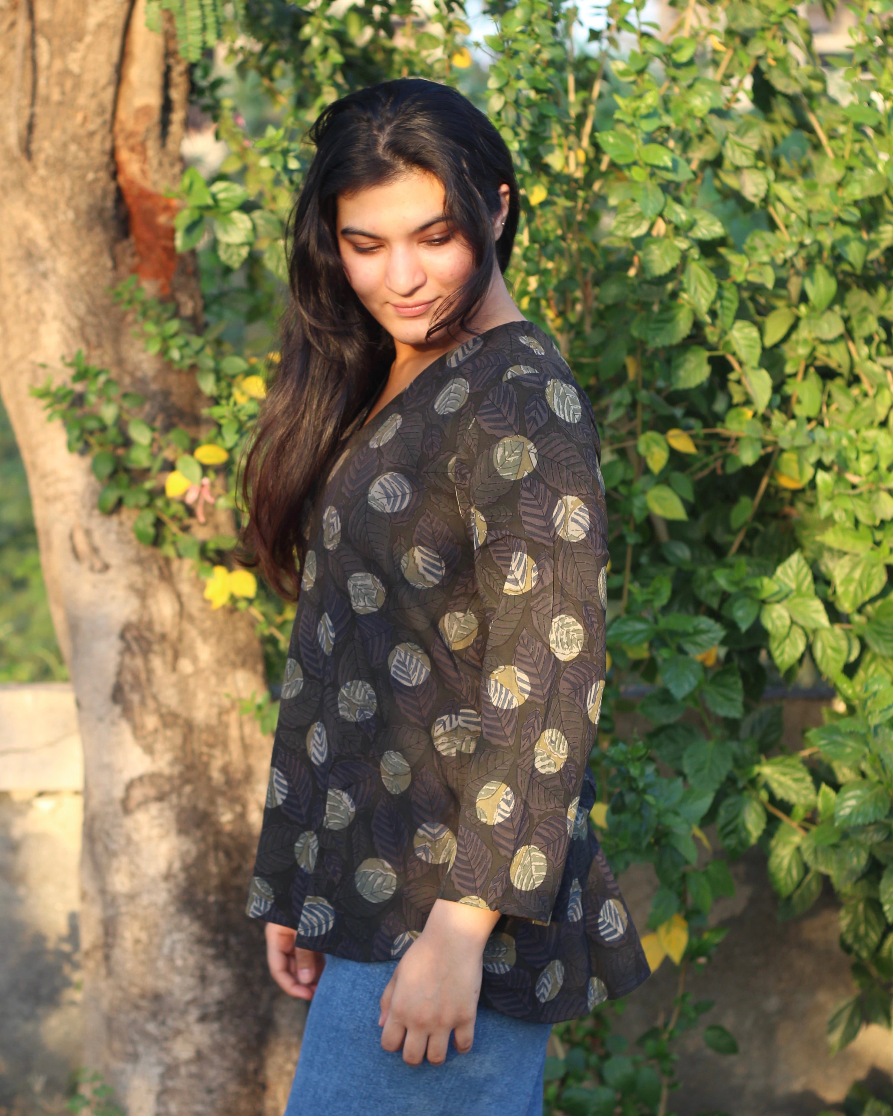 Stylish brown printed short kurta with dark contrasting lead print, featuring a V-neck, 3/4 sleeves, and small side cuts for a chic look