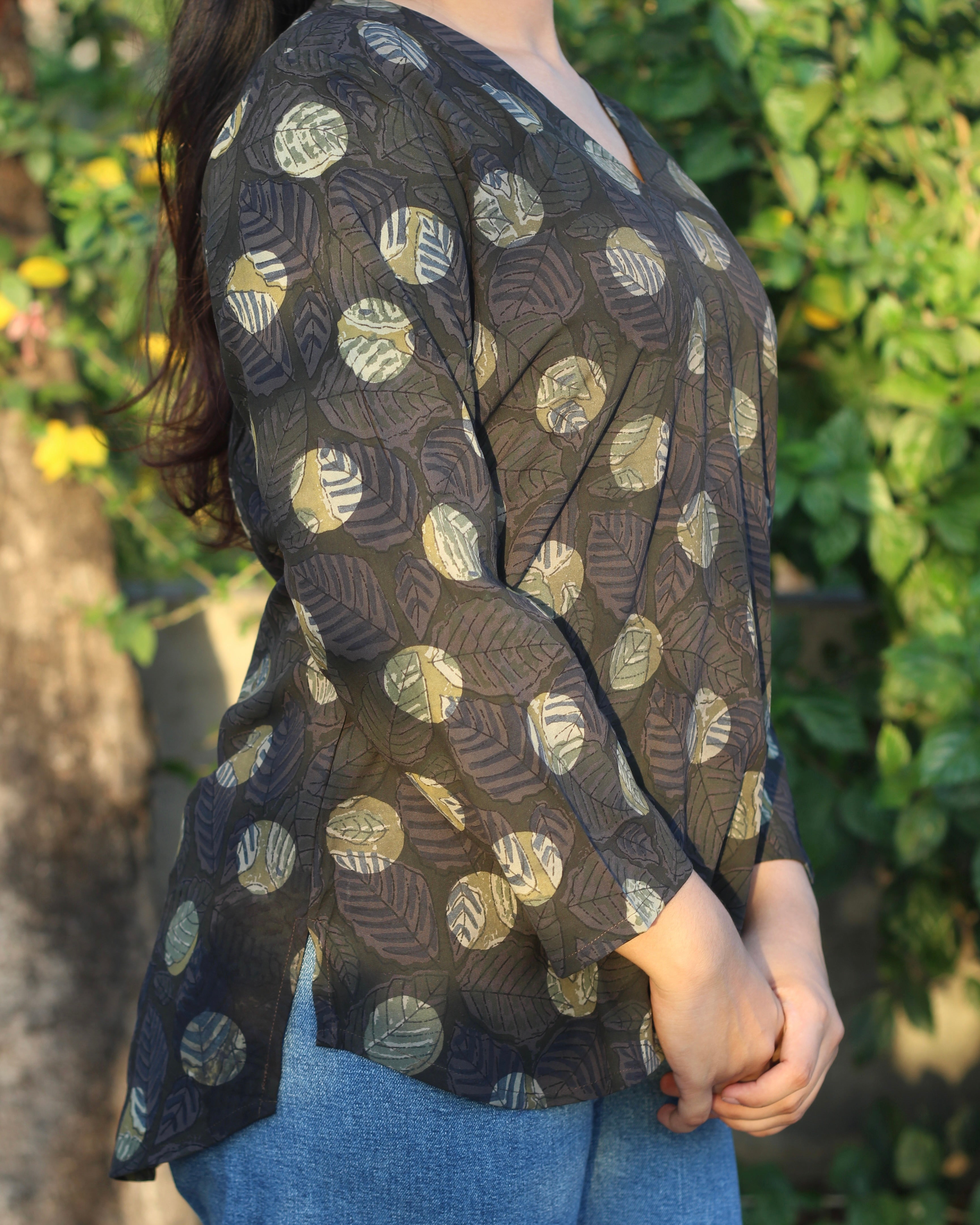 Stylish brown printed short kurta with dark contrasting lead print, featuring a V-neck, 3/4 sleeves, and small side cuts for a chic look