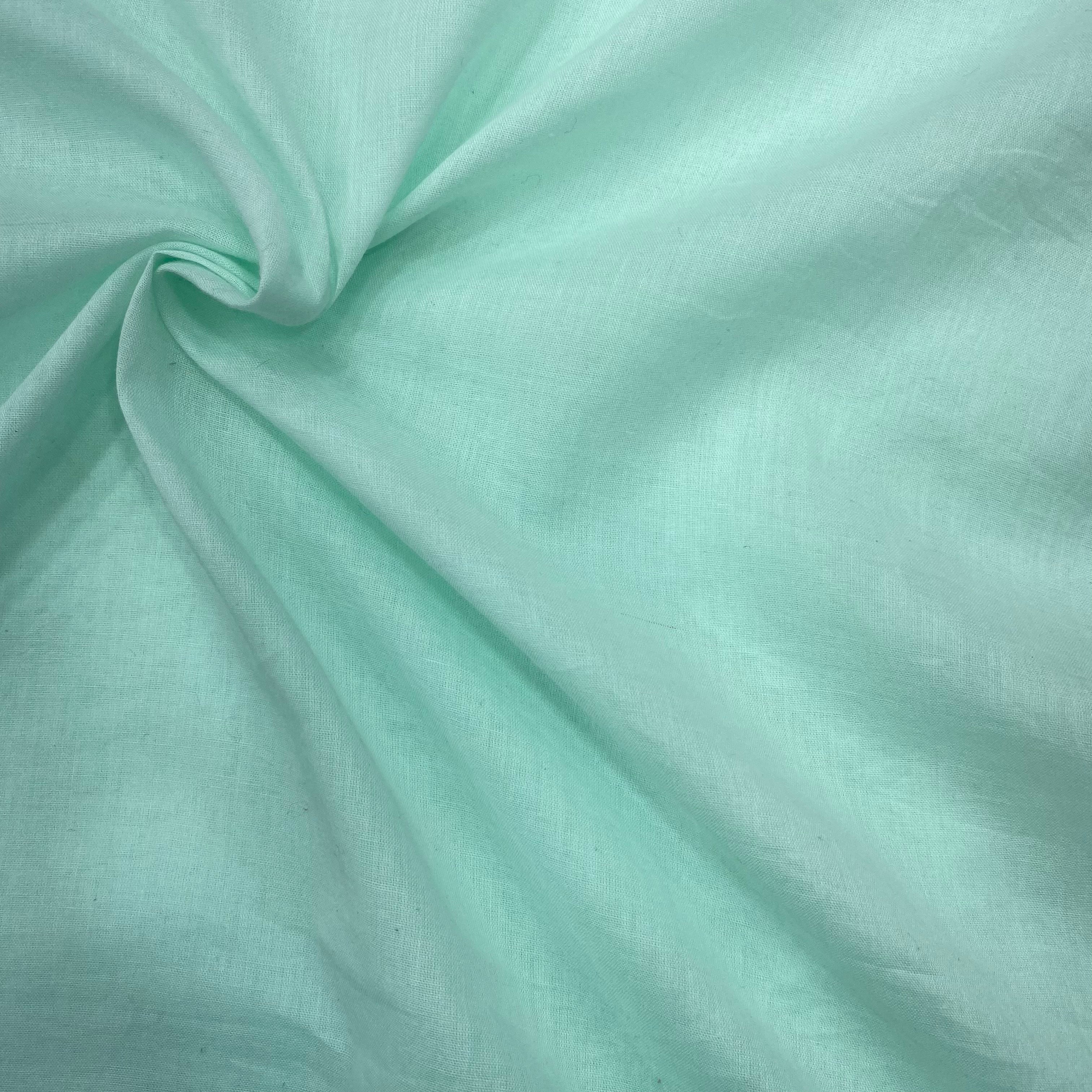 Elegant drape of lightweight mul cotton fabric in a soft, sky blue shade.