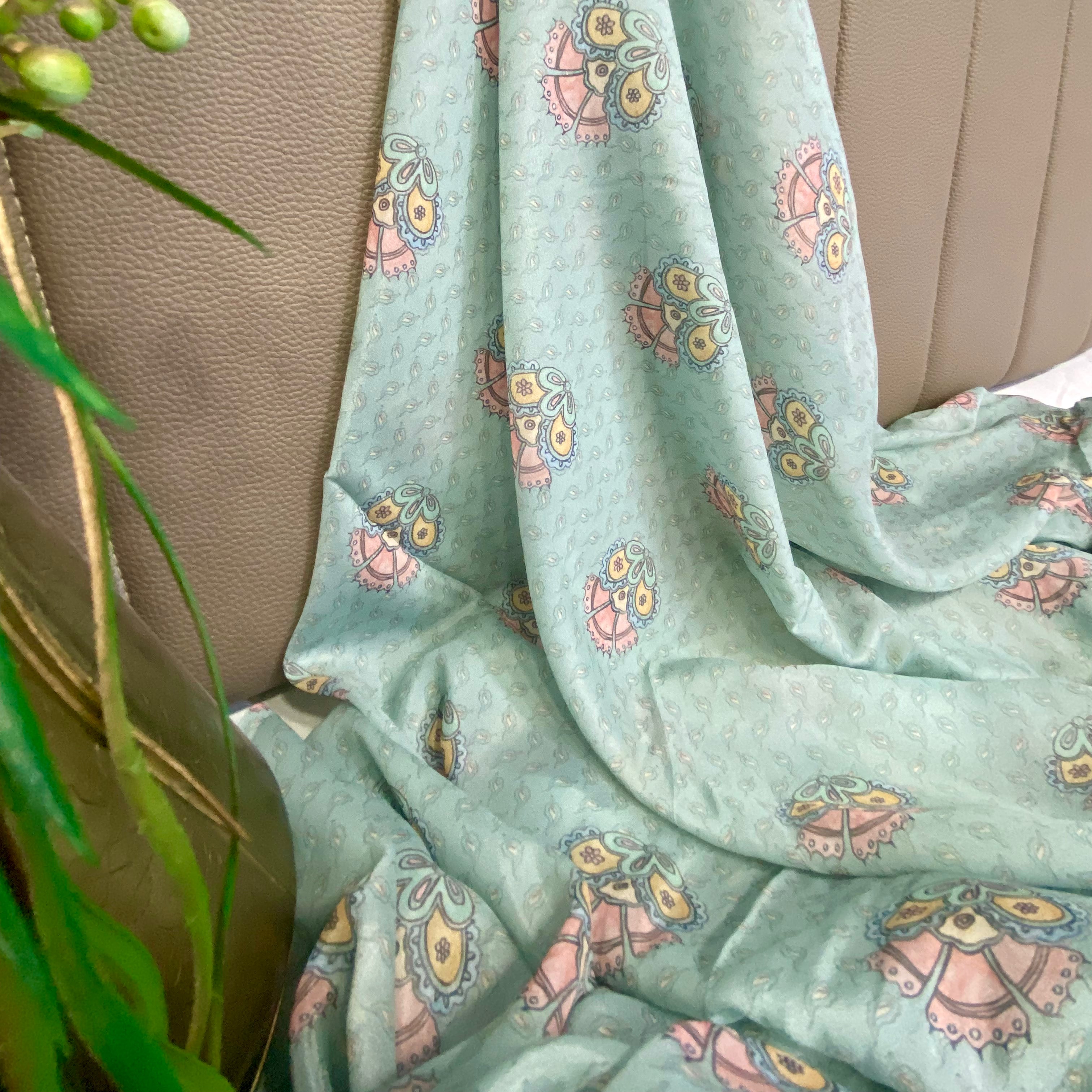 Sky Blue fabric with a colourful floral design and traditional motifs per meter
