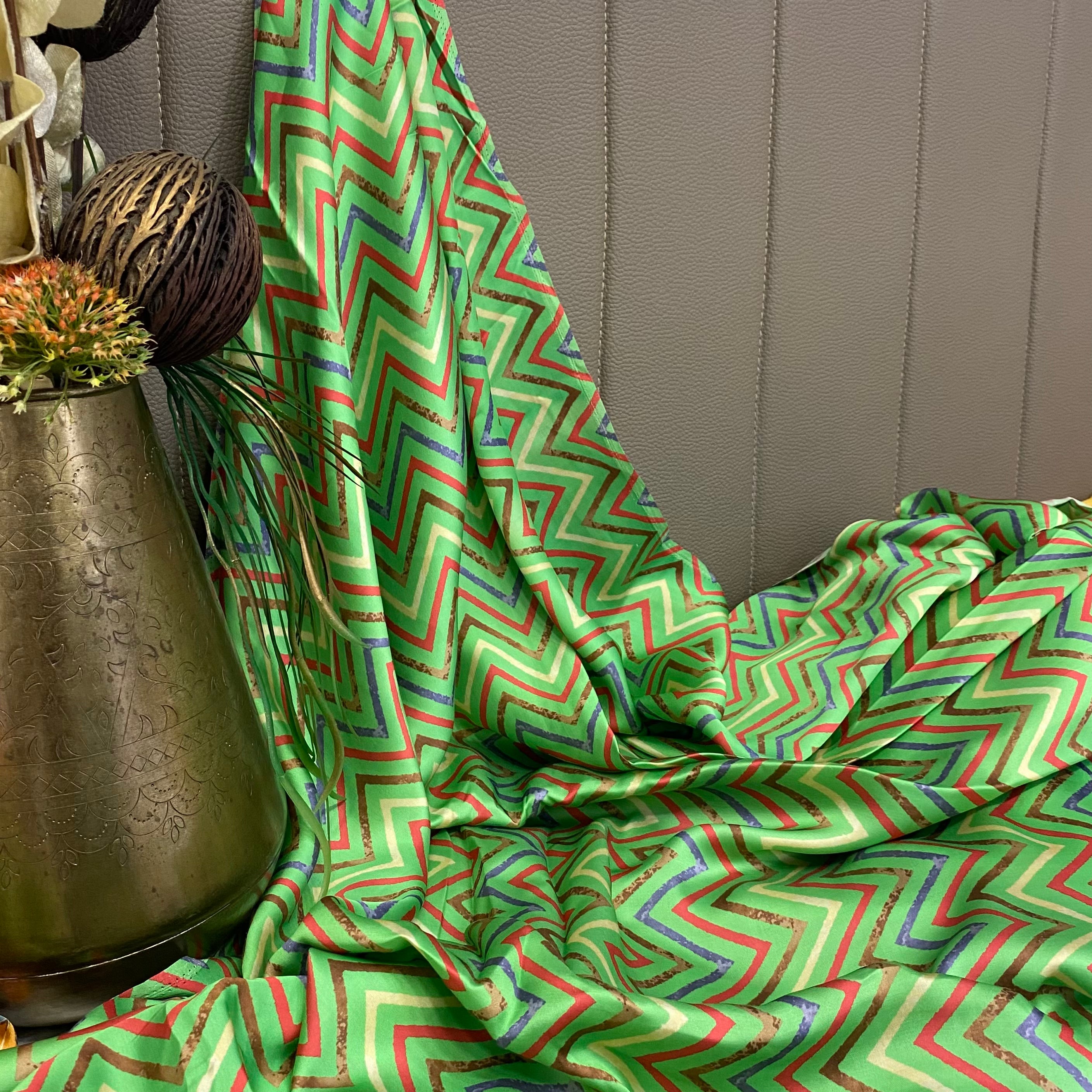 Green top and bottom with multicoloured floral pattern on top and zigzag bottom, per meter price