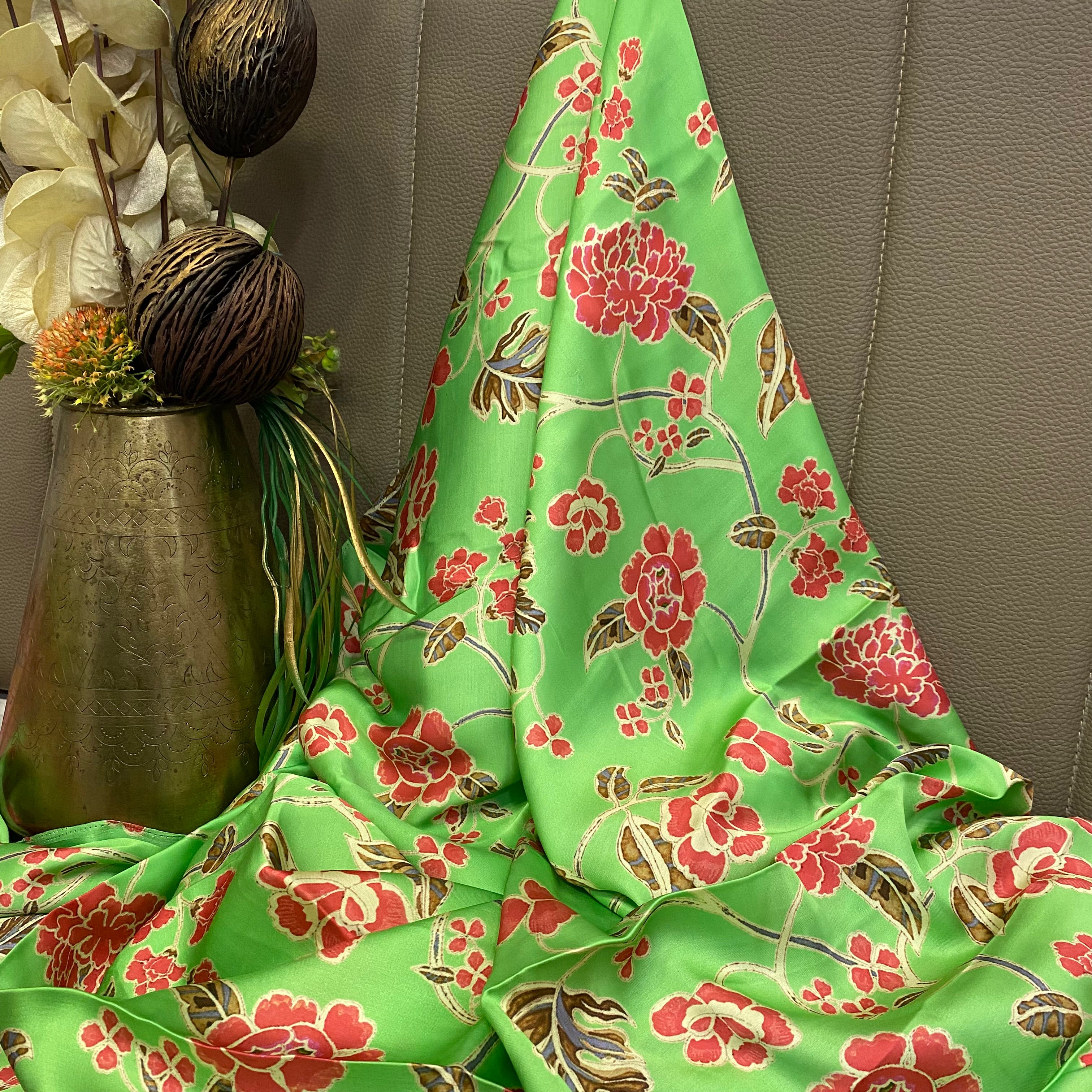 Green top and bottom with multicoloured floral pattern on top and zigzag bottom, per meter price