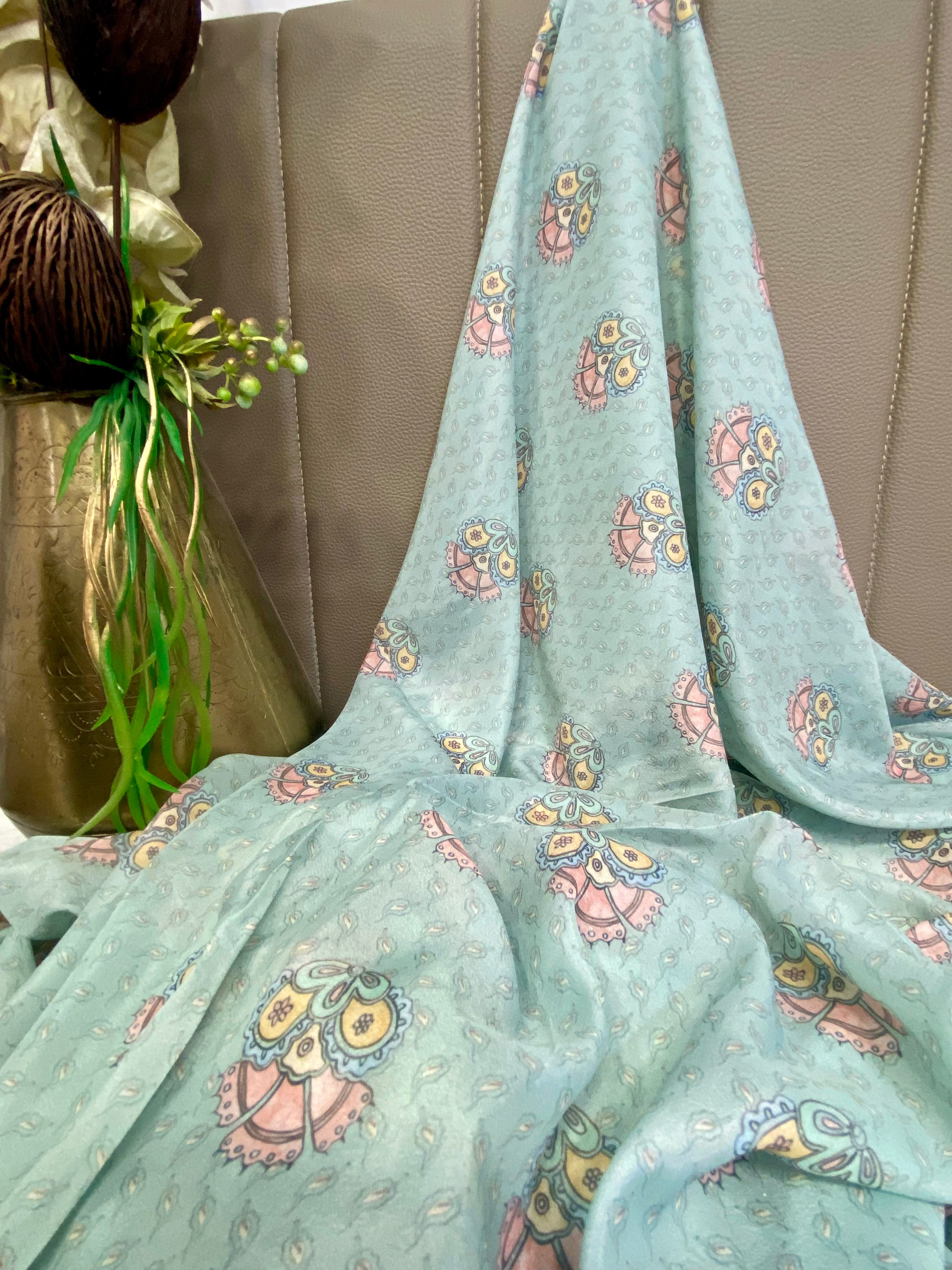 Sky Blue fabric with a colourful floral design and traditional motifs per meter