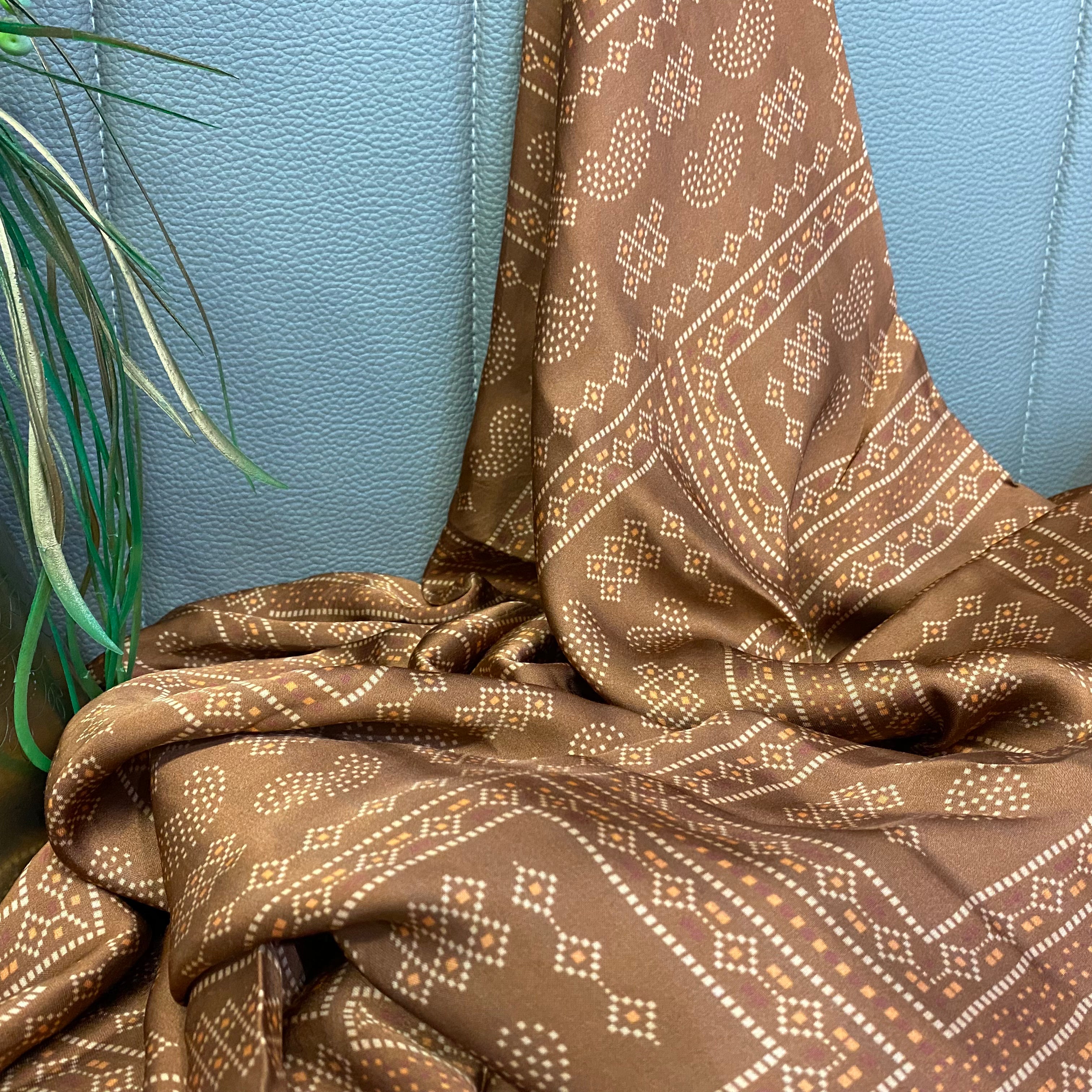 Paisley Motif print on brown shaded modal satin fabric per meter