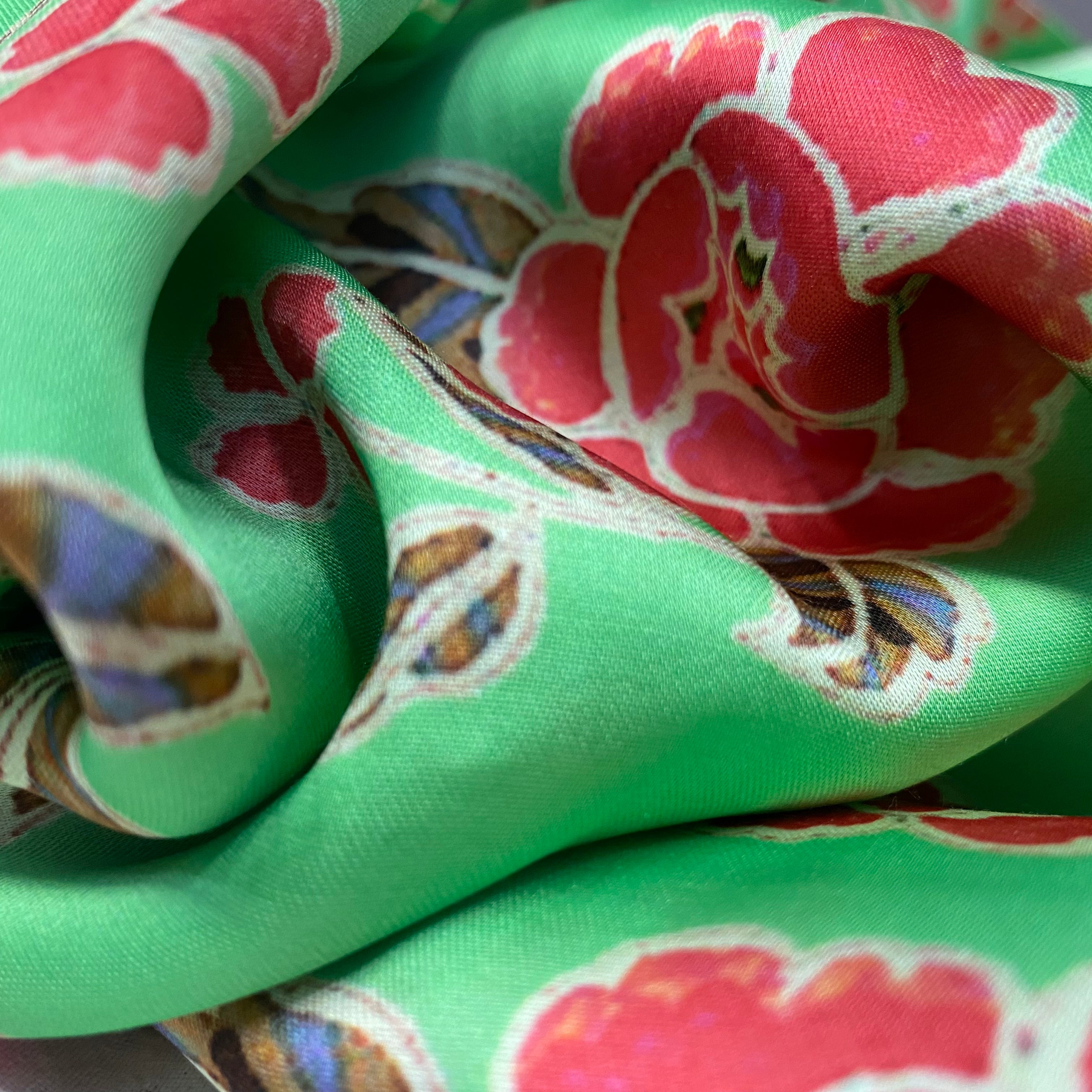 Green top and bottom with multicoloured floral pattern on top and zigzag bottom, per meter price